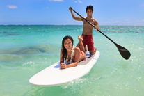 young couple with their paddle board in amelia island